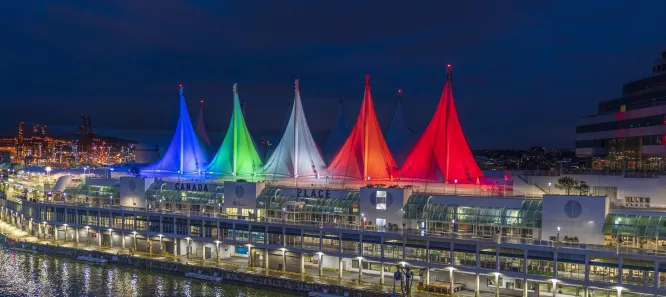 Photo of Canada Place's sails illuminated in multiple colours