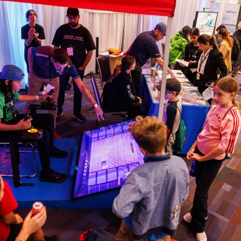 The next generation of workers try out the crane simulator at the ILWU Canada booth, in the Maritime Career Zone.