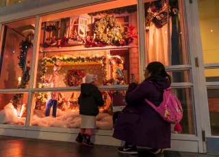 Child and mom in front of Woodwards windows at Canada Place